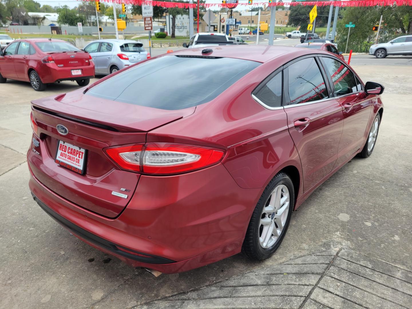 2013 Red Ford Fusion (3FA6P0HR3DR) with an 1.6L I4 F DOHC 16V engine, Automatic transmission, located at 503 West Court, Seguin, TX, 78155, (830) 379-3373, 29.568621, -97.969803 - 2013 Ford Fusion SE with a 1.6L I4 F DOHC 16V, Automatic, Tilt, Cruise, AM/FM/CD Stereo, Power Windows, Locks, Seat and Side Mirrors, Bluetooth, Automatic Headlights, Tinted Windows, Alloy Wheels, Rear Defroster and more!! - Photo#2